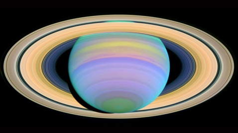 Saturn is seen here in ultraviolet light. Particles in Saturn's atmosphere reflect different wavelengths of light in discrete ways, causing some bands of gas in the atmosphere to stand out vividly in an image, while other areas will be very dark or dull. This image reveals the properties and sizes of aerosols in Saturn's gaseous makeup. For example, smaller aerosols are visible only in this ultraviolet image, because they do not scatter or absorb visible or infrared light, which have longer wavelengths.
